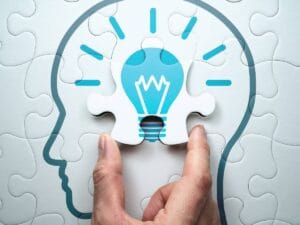 Grafika pokazująca zarys głowy z żarówką wewnątrz.