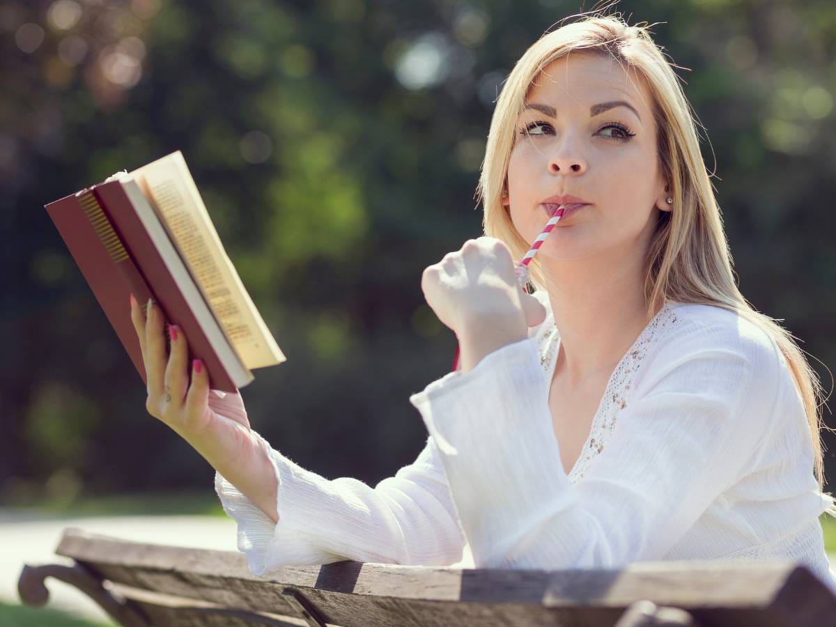Dziewczyna w białej bluzce z książką w ręku